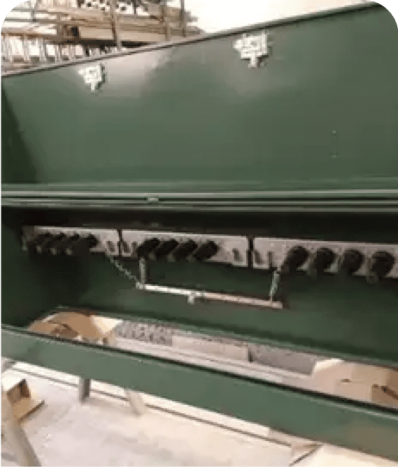 Green industrial machine with multiple knobs.