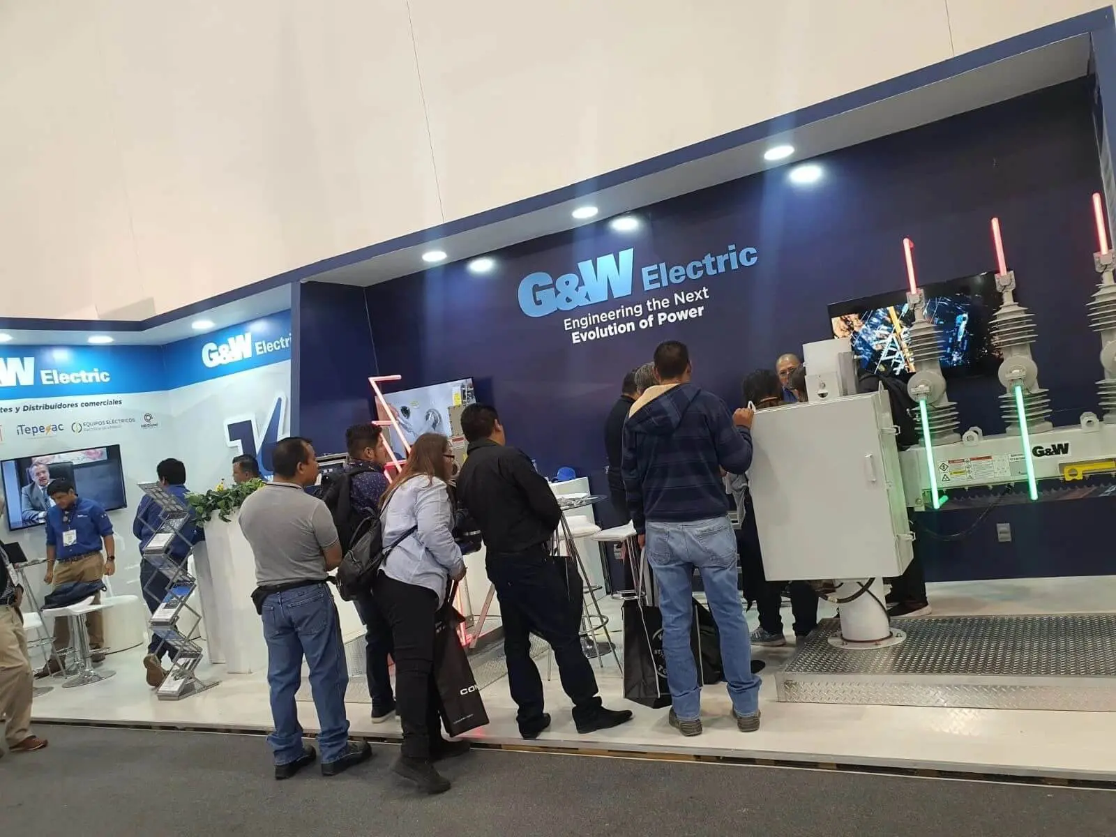 People visiting G&W Electric exhibition booth.