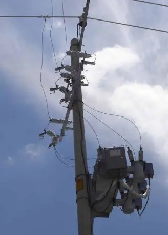Utility pole with electrical wires and equipment.