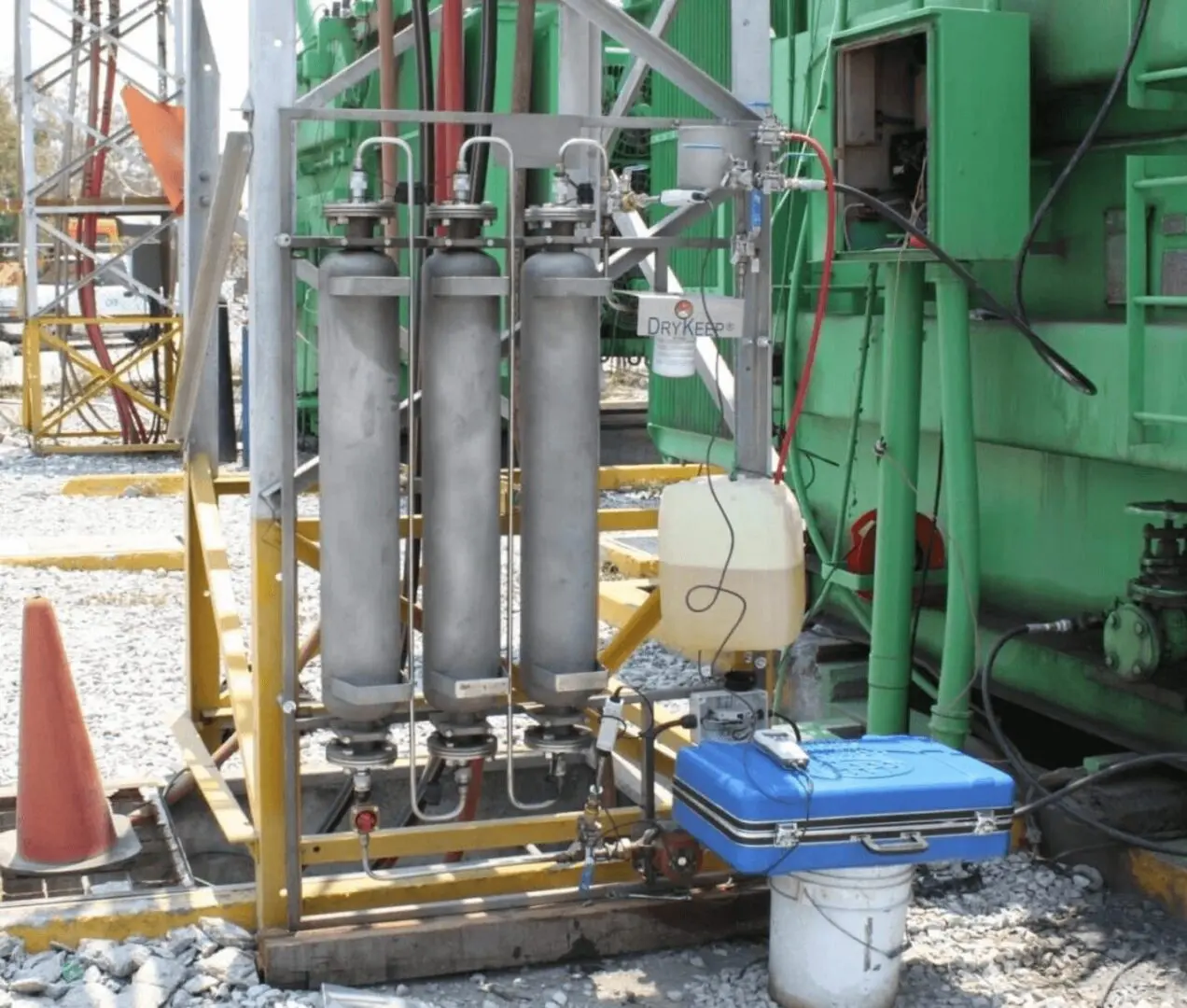 Industrial equipment with cylinders and control box.