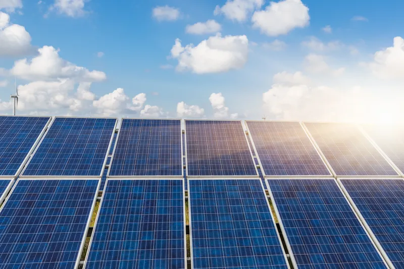 Solar panels under a bright blue sky.
