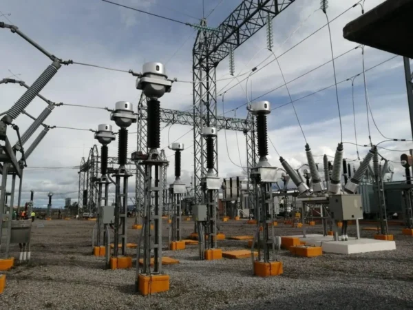 Electrical substation with transformers and cables.
