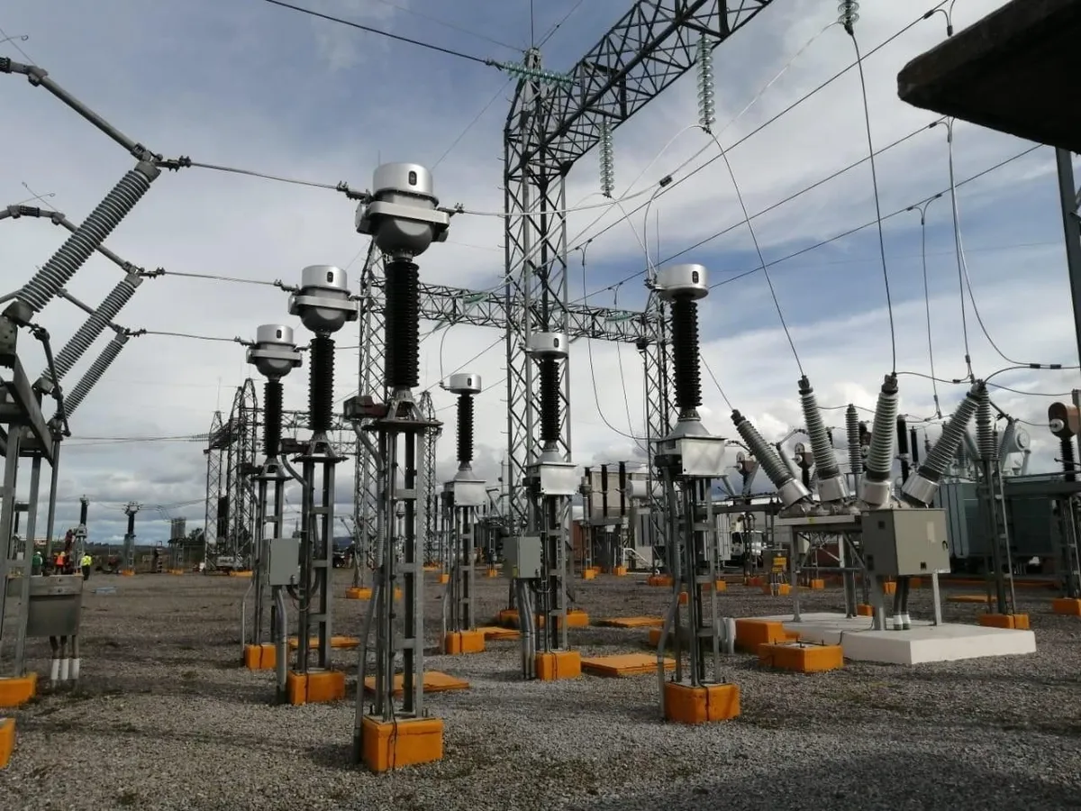Electrical substation with transformers and cables.
