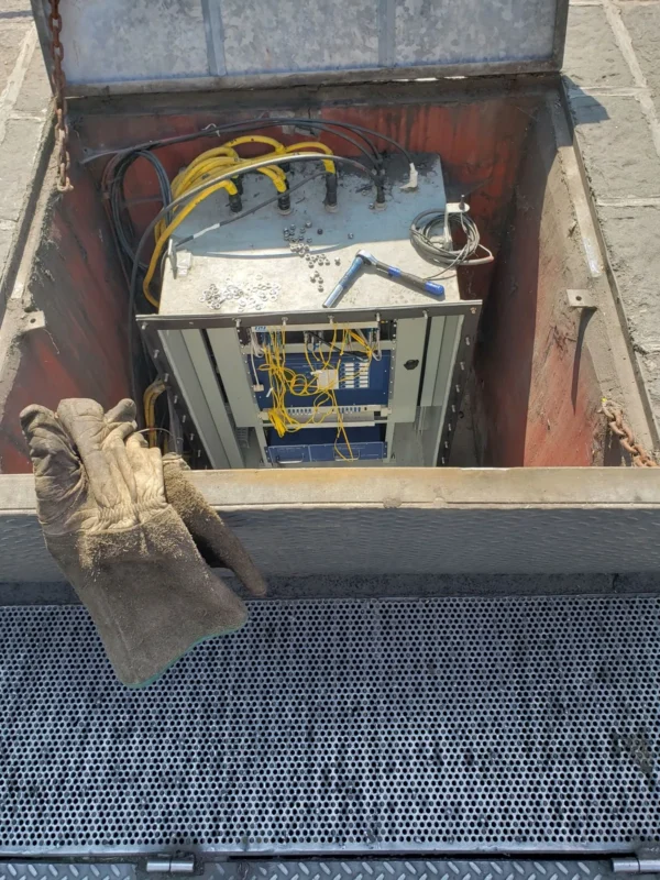 Electrical equipment in an open underground box.