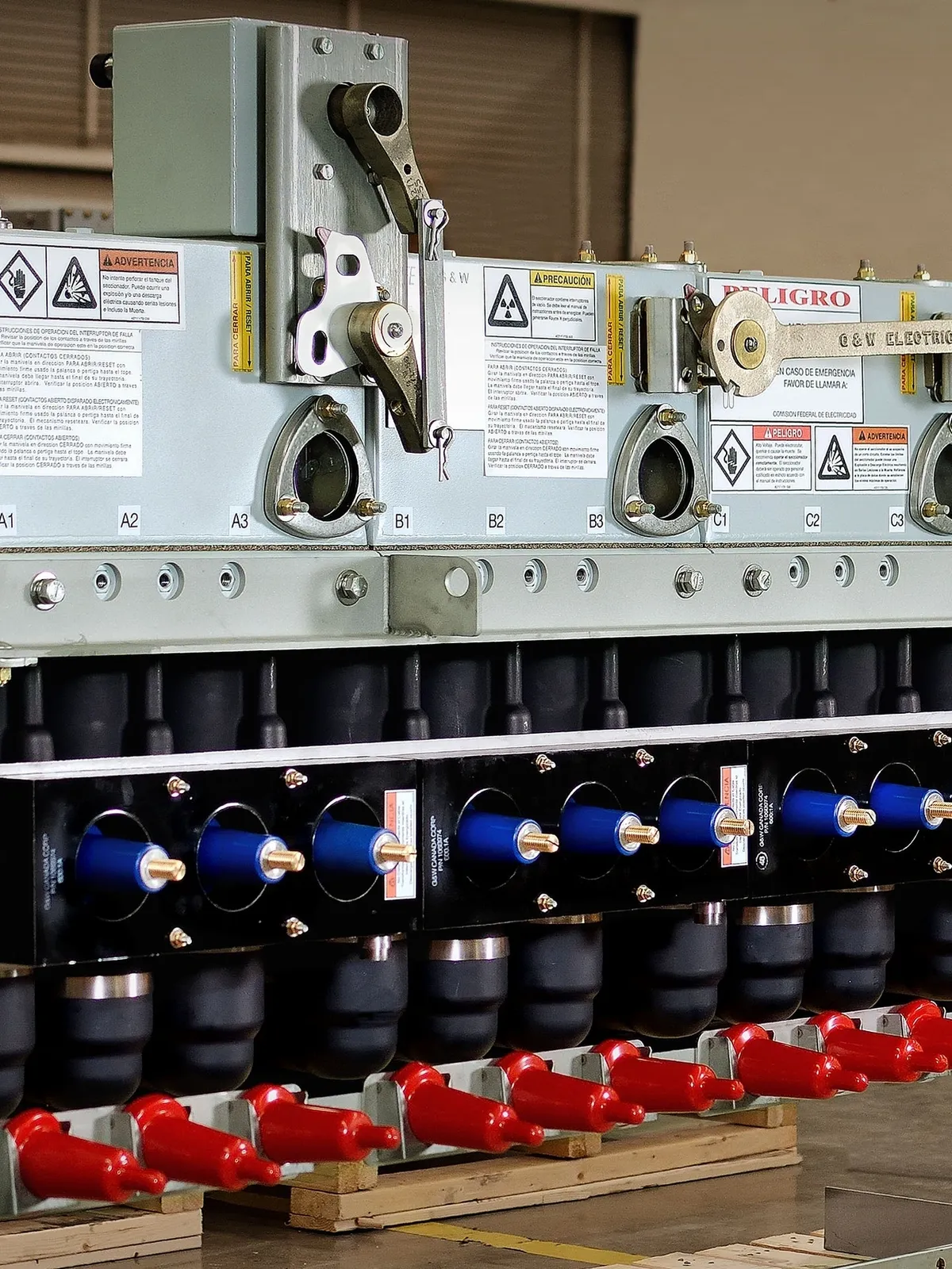 Industrial electrical equipment with safety warnings visible.