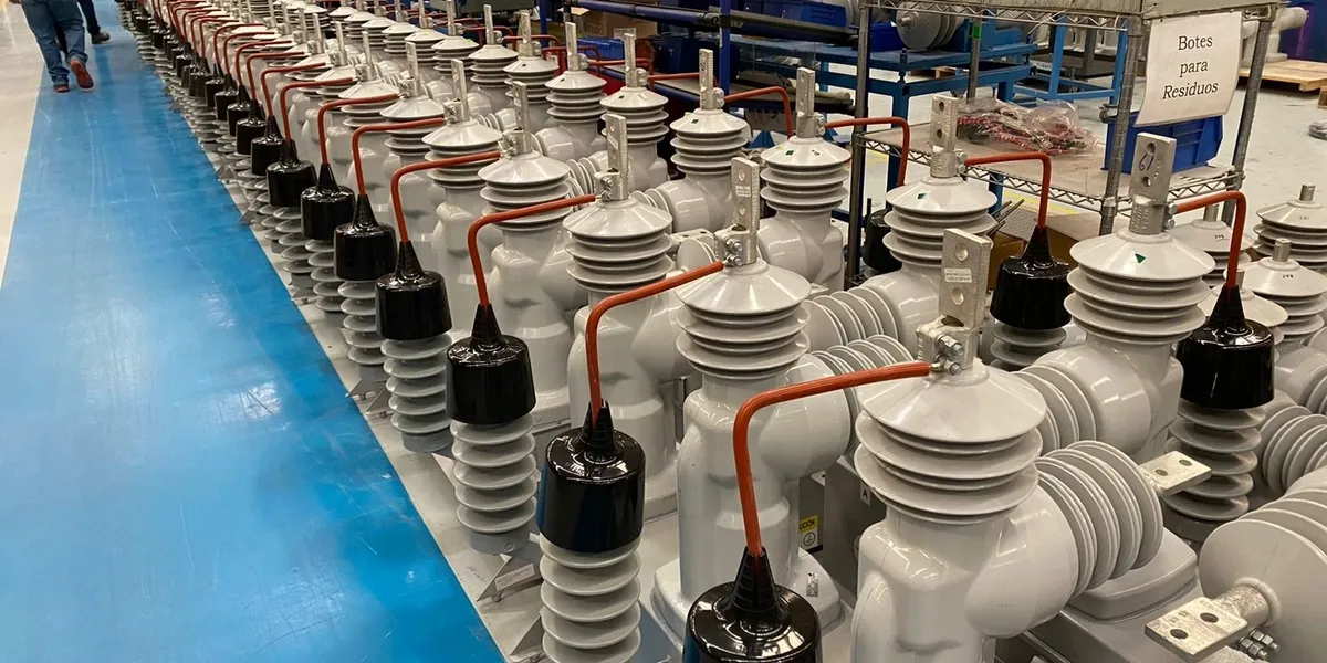 Row of industrial electrical insulators in factory.