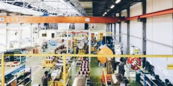 Factory interior with machinery and workers.